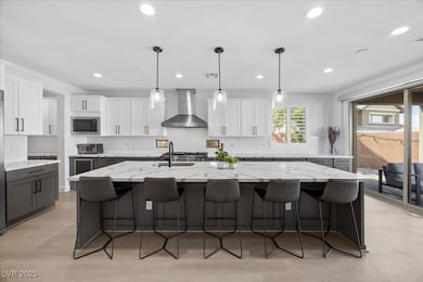 Kitchen with wall chimney range hood, stainless st