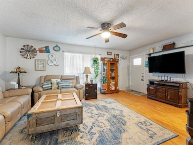 Living room featuring wood-type flooring, ceiling 