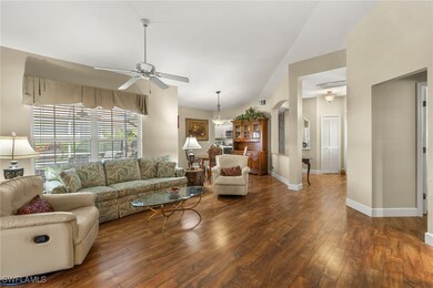 Living room with dark wood-type flooring, baseboar