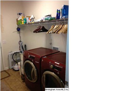 Laundry room with shelves and garage access.