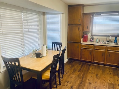 Dining area with dark wood-style flooring