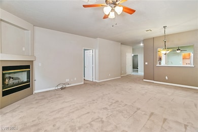 Living room, fireplace, ceiling fan fixture, and k