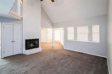 Unfurnished living room featuring ceiling fan, a f