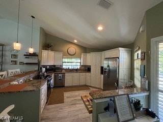 Kitchen with vaulted ceiling, light hardwood / woo