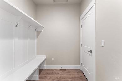 Mudroom featuring wood finished floors and baseboards