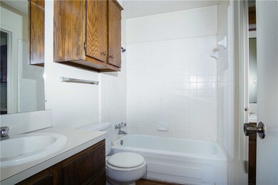 Bathroom featuring vanity, tub / shower combinatio