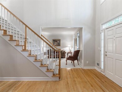 Foyer entrance with a towering ceiling, wood finis