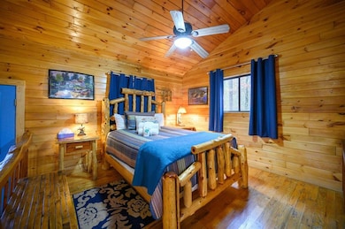 Bedroom with ceiling fan, vaulted ceiling, wooden 