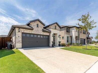 View of front of property with a garage and a front yard