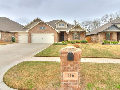 View of front of home with a garage, brick siding,