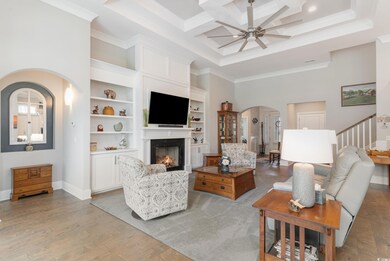 Living room featuring ornamental molding, light ha