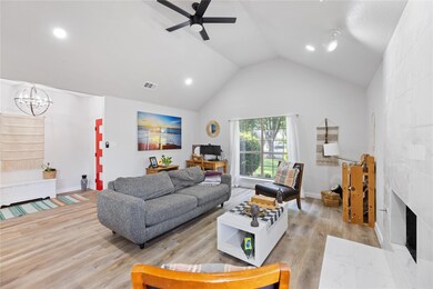 Living room featuring high vaulted ceiling, light 