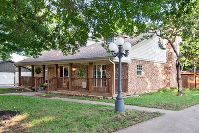Single story home with a front lawn and a porch
