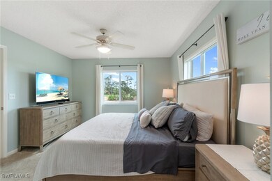 Bedroom with a ceiling fan, a textured ceiling, li