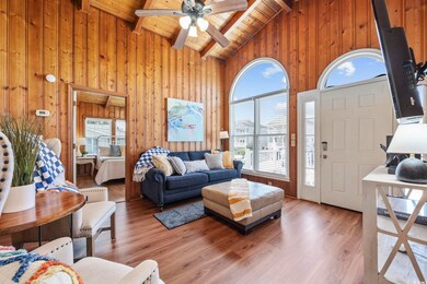 Living room featuring wood ceiling, wood walls, be