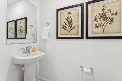 (Photo of a model home, actual homes finishes will vary) Half bath conveniently located on the main floor!