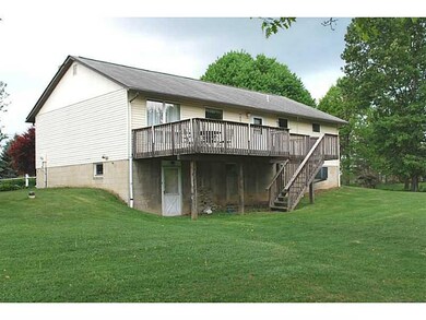 Exterior Back. Large deck with steps to yard.  Wal