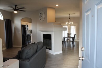 Living room featuring baseboards, a tiled fireplac