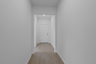 Hallway featuring wood finished floors and recess