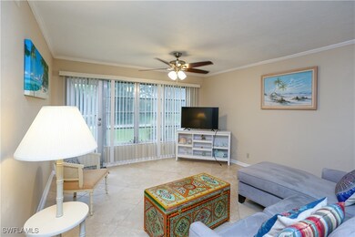 Living room featuring crown molding, ceiling fan,