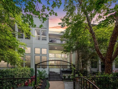 Modern 3-story home with a sleek exterior, large w