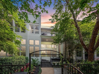 Modern 3-story home with a sleek exterior, large w