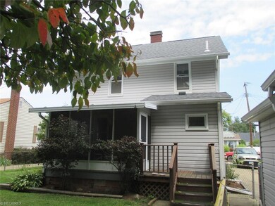 Rear view with screened porch and fenced yard