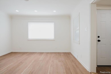 Spare room featuring healthy amount of natural light, light wood-type flooring, and recessed lighting