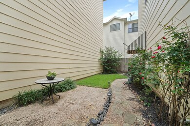 The gated entrance opens to a flagstone paved walk