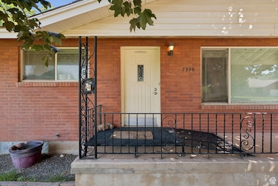 Entrance to property featuring brick siding