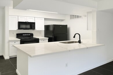 Kitchen features stunning quartz countertops paire