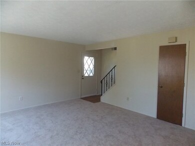 Spacious living room with new neutral carpeting.