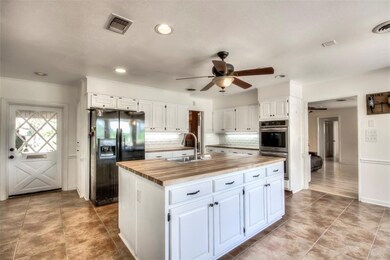 Kitchen with door leading to 2 car carport and rig
