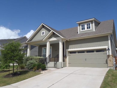 Craftsman-style home featuring concrete driveway, an attached garage, and a porch