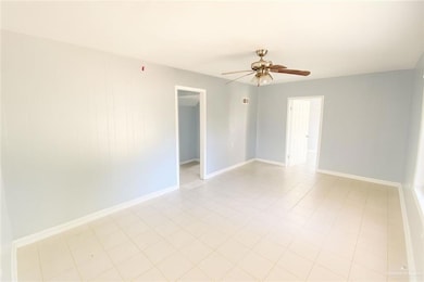 Unfurnished room featuring ceiling fan and light tile patterned floors