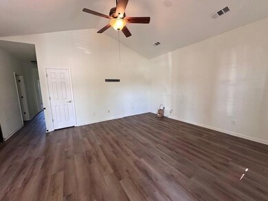 Unfurnished room featuring ceiling fan, dark wood-style flooring, and high vaulted ceiling