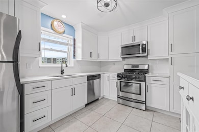 Updated kitchen with soft closing cabinetry and quartz countertops.