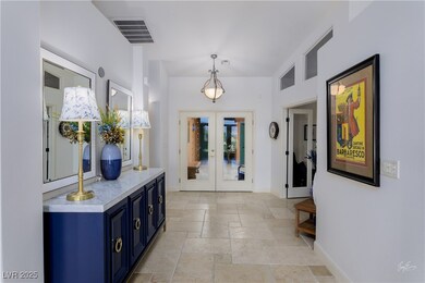 Foyer featuring stone tile flooring, french doors,