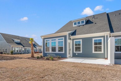 Rear view of property featuring a patio area, a sh