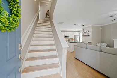 You are greeted by first floor living with newly refinished hardwood flooring and a staircase featuring wooden treads.