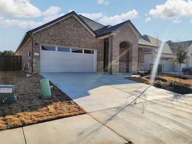 View of front facade featuring brick siding, conc