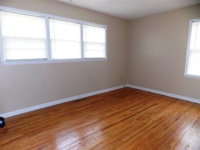 Master bedroom has four windows and gleaming hard 