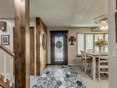 Entryway with wood walls, a textured ceiling, ceil