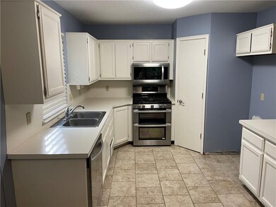 Kitchen has pantry and plenty of countertop space.