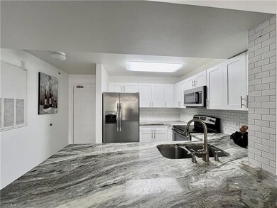 Kitchen with sink, stainless steel appliances, bac