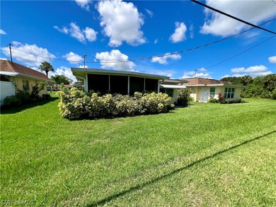 Back of property with a yard