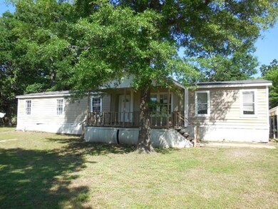 Rear view of house with a yard and a porch