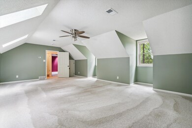 Additional living space featuring ceiling fan, car