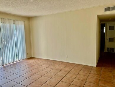 Empty room with visible vents, a textured ceiling
