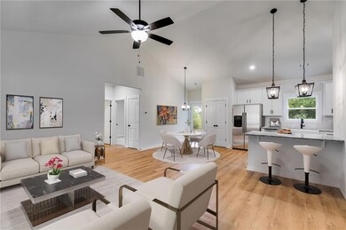 Living room with light wood-style floors, plenty of natural light, high vaulted ceiling, and ceiling fan